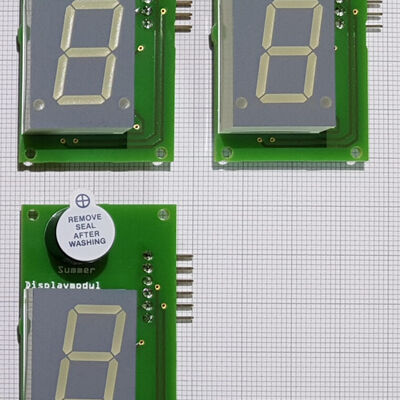 Three assembled Displaymodul boards: the 7-segment digit, the piezo buzzer, and the 6-pin header.